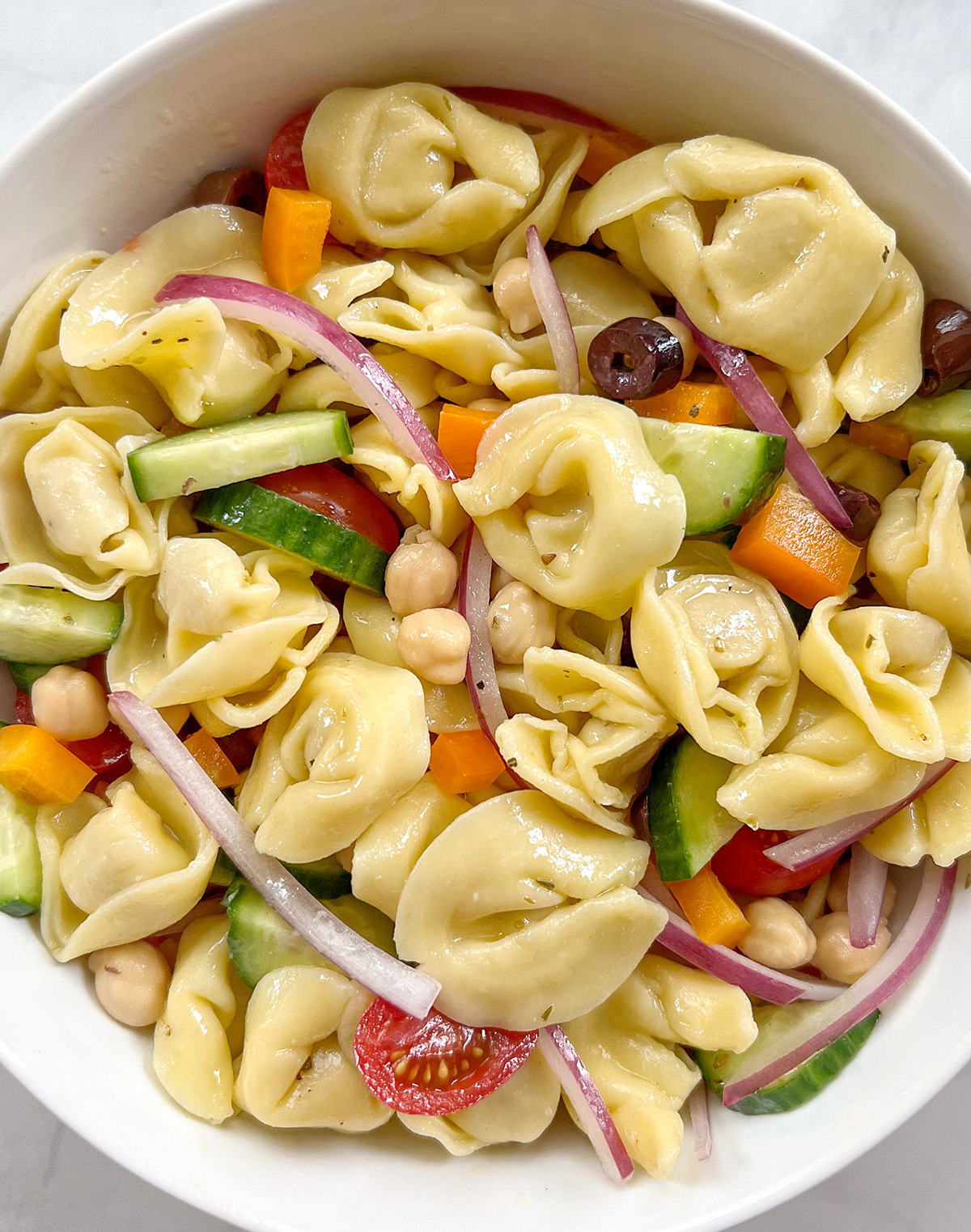 vegan tortellini pasta salad in white bowl.